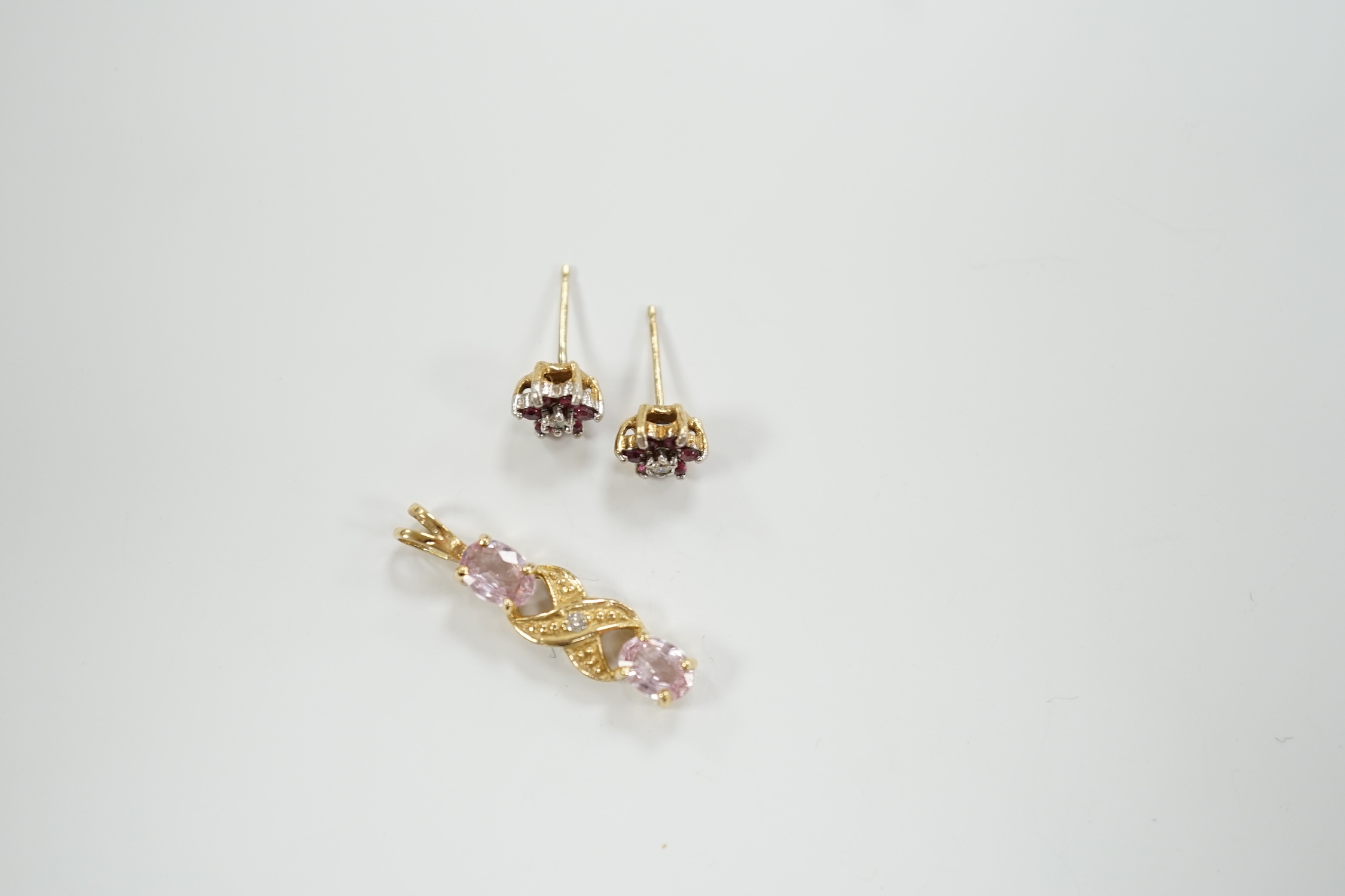 A modern 9ct gold and gem set pendant, 25mm and pair of similar ear studs, gross weight 2.8 grams.